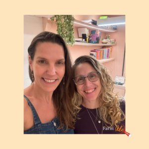 selfie com duas mulheres brancas sorrindo para a foto. ao fundo tem uma estante com alguns livros e uma planta pendurado num vaso.